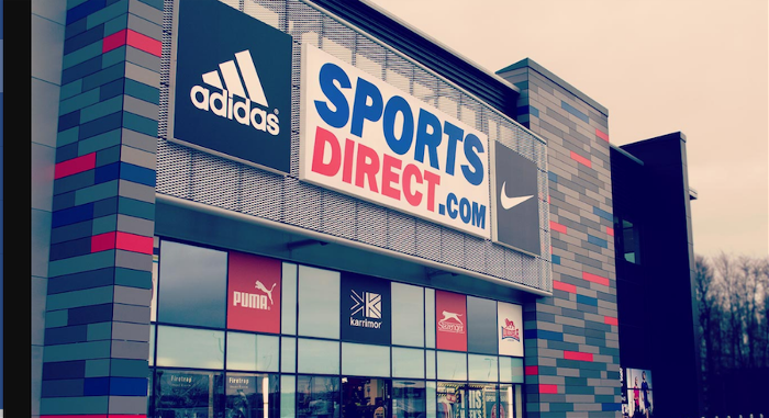 Sports direct profits drop more than half